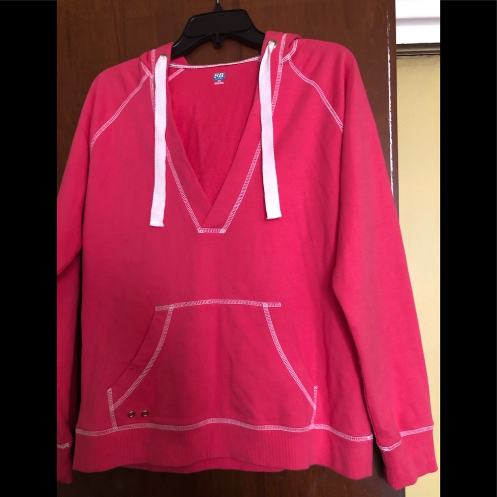Hoodie - Coral color with white stitching.